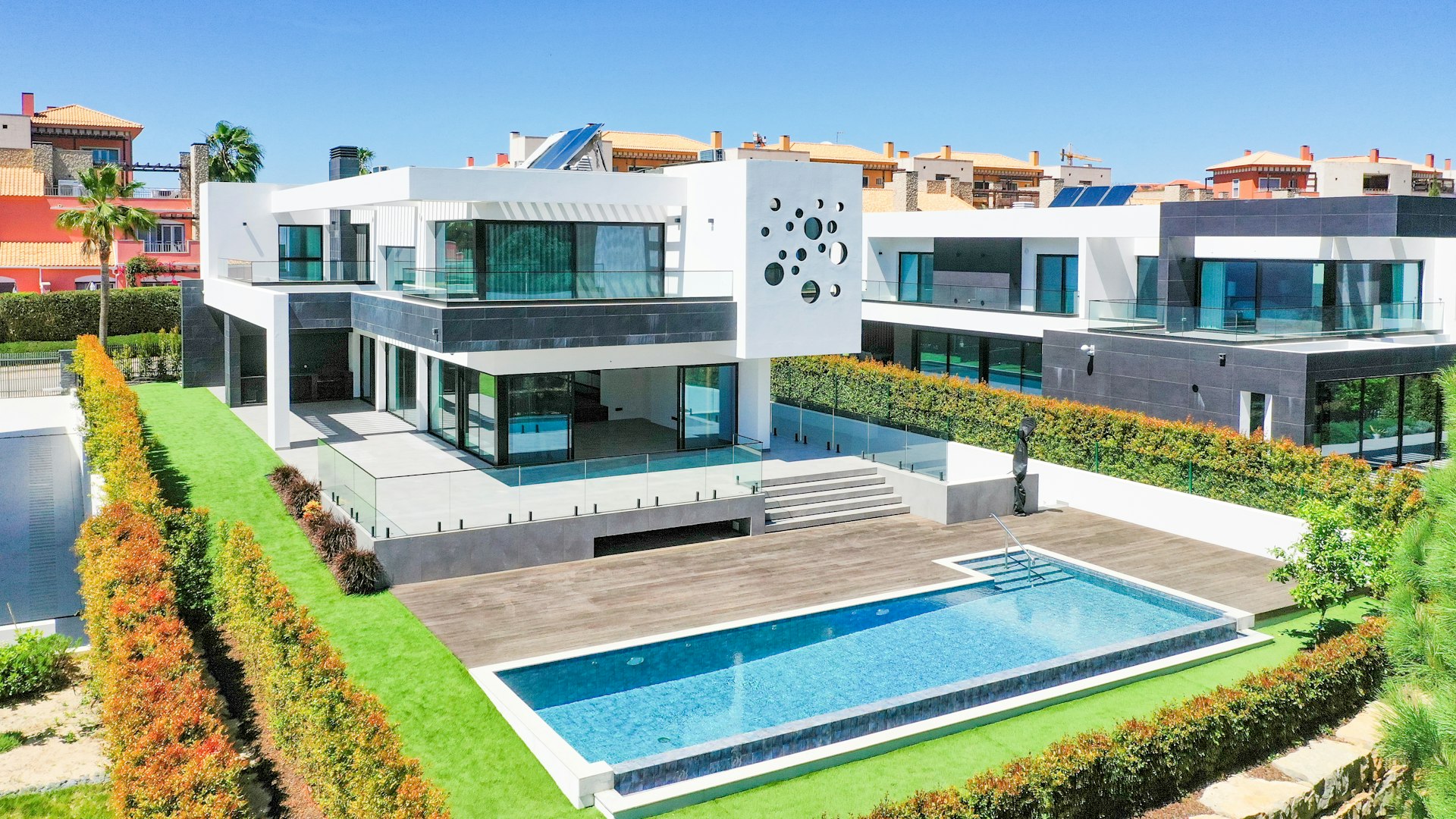 a large white house with a pool in front of it